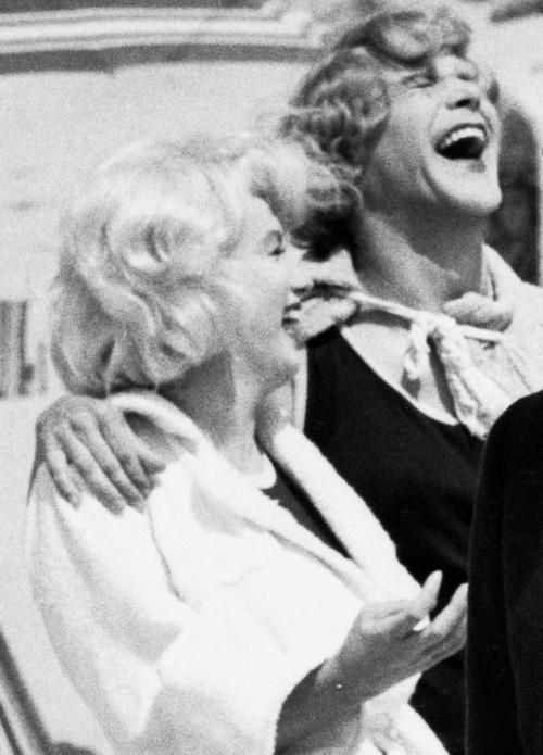 black and white photograph of three women laughing