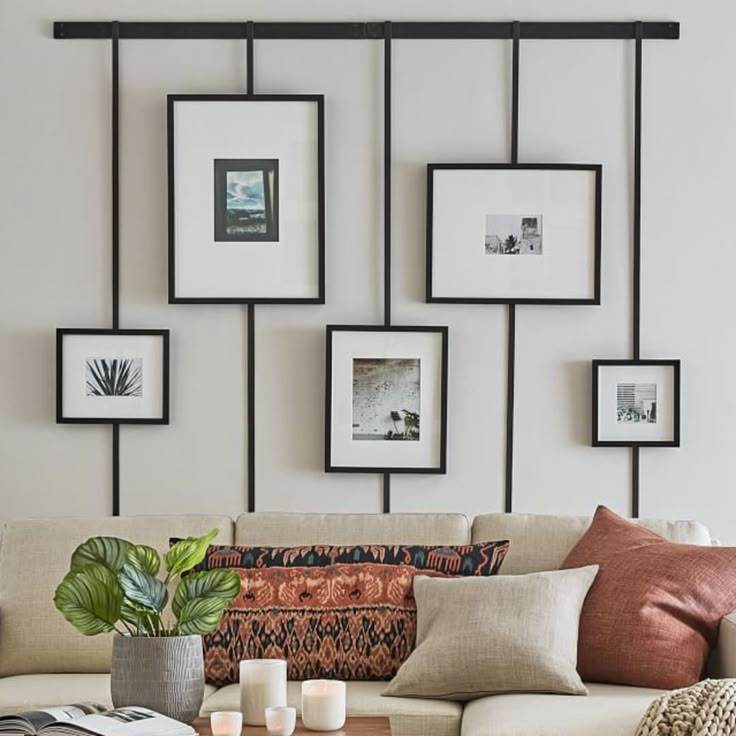 a living room filled with lots of furniture and pictures on the wall above it's coffee table