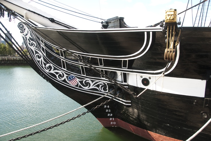 a large black and white boat docked in the water