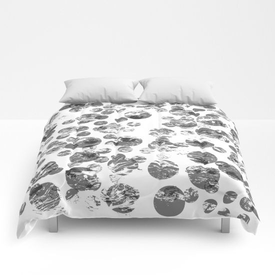 a black and white photo of a bed with two pillows on top of the covers