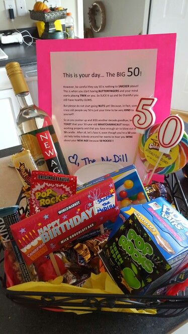 a birthday gift basket for someone's 50th with wine, candy and snacks in it