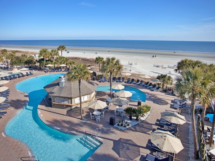 an aerial view of the beach and pool area