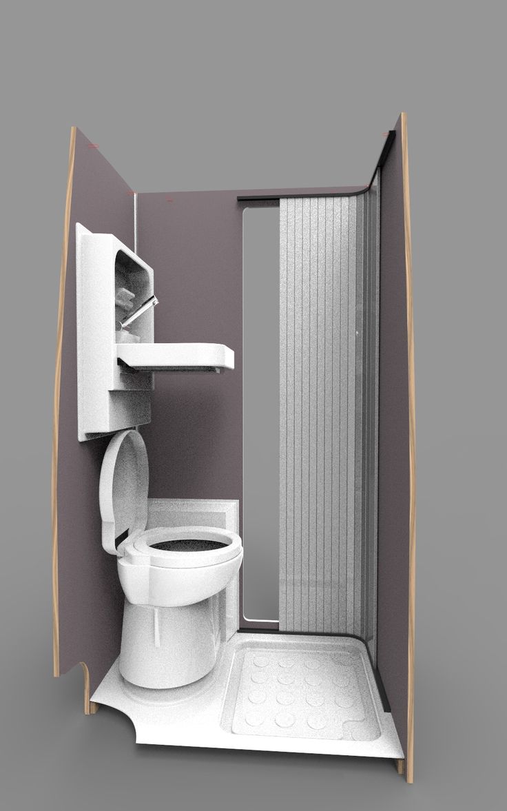 a bathroom with a toilet, sink and shower stall in the wall next to it