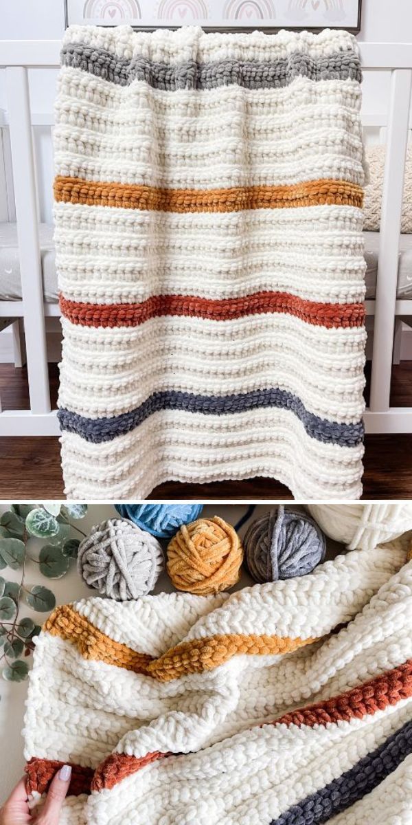 crocheted blanket made with yarn and yarn balls on the floor next to a crochet afghan