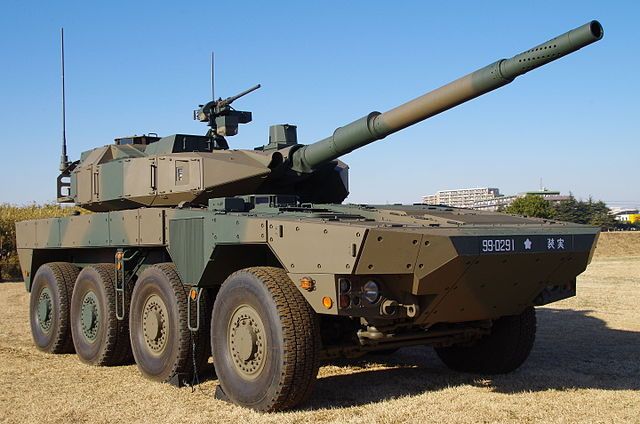 an army vehicle parked on top of a dry grass field