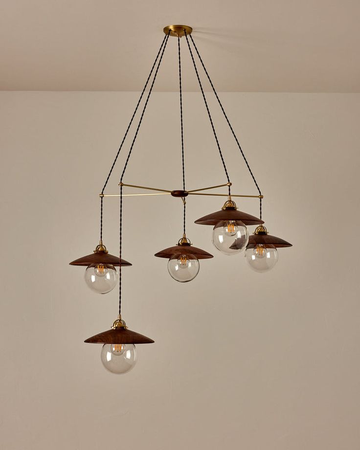 three lights hanging from the ceiling in a room