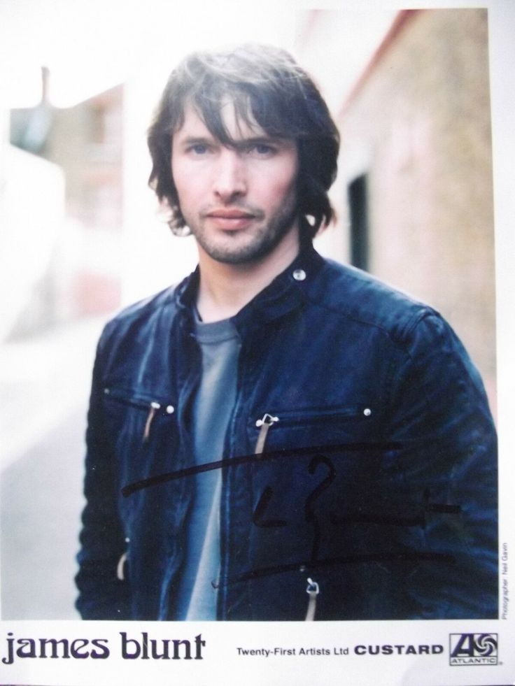 a man with long hair wearing a leather jacket