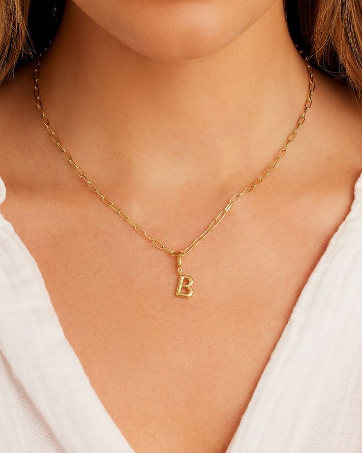 Description Personalize your favorite chain necklace with this playful helium alphabet charm. Wear your initials or a loved one's - you can make a set here. Product Details Total drop 11/16" Letter measures 5/16" by 3/8" Hinge closure measures 3/16" by 5/16" Available in 18k gold plated brass Avoid contact with anything containing derivatives of alcohol Everyday Yellow Gold Charm Necklace With Lobster Clasp, Dainty Everyday Charms With Initial Pendant, Dainty Everyday Initial Pendant Charms, Classic Gold Plated Initial Pendant Necklace, Yellow Gold Monogram Initial Necklace, Classic Initial Pendant Necklace With Charms, Monogram Initial Pendant Jewelry, Monogram Initial Pendant Jewelry For Everyday, Classic Gold Monogram Charm Necklace