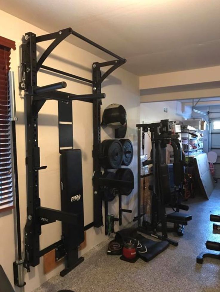 a home gym is shown in the corner of a room with lots of exercise equipment