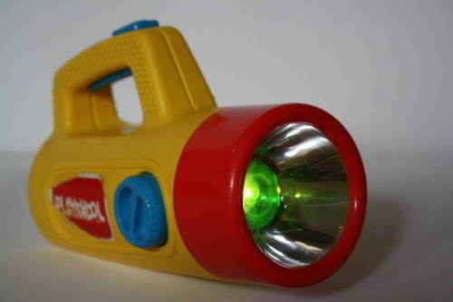 a yellow and red flashlight on a white surface