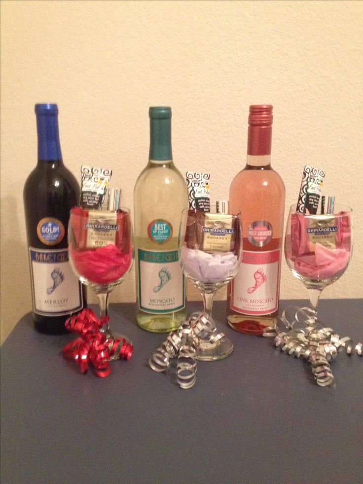 several wine bottles and glasses on a table next to each other with silver ornaments around them