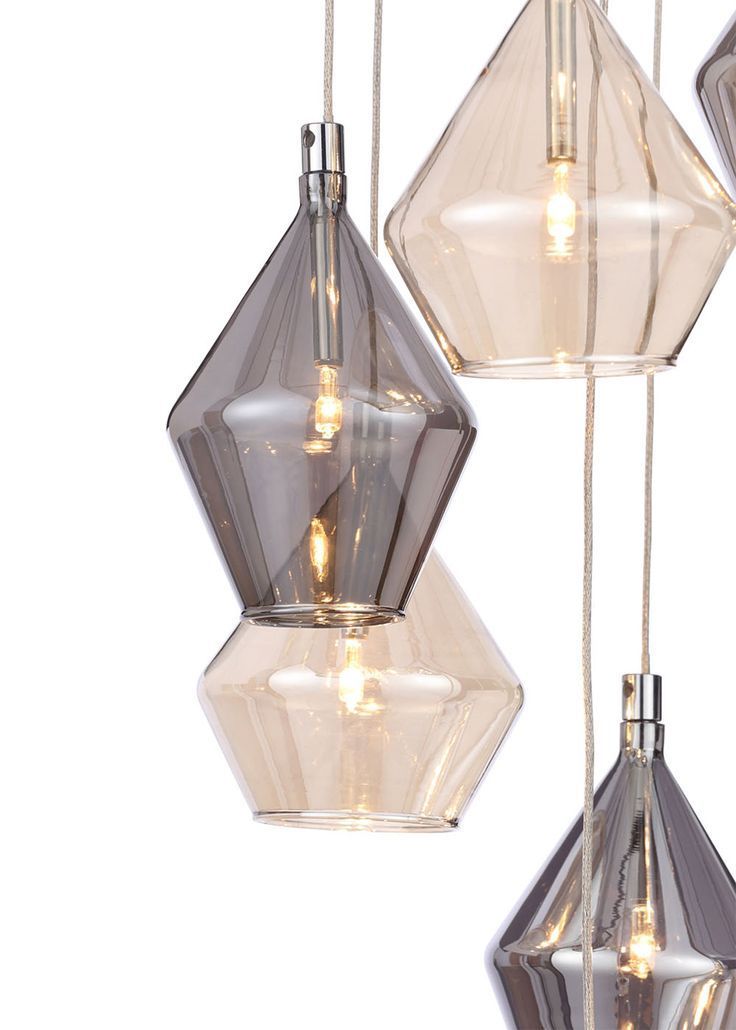 three clear glass pendant lights hanging from strings