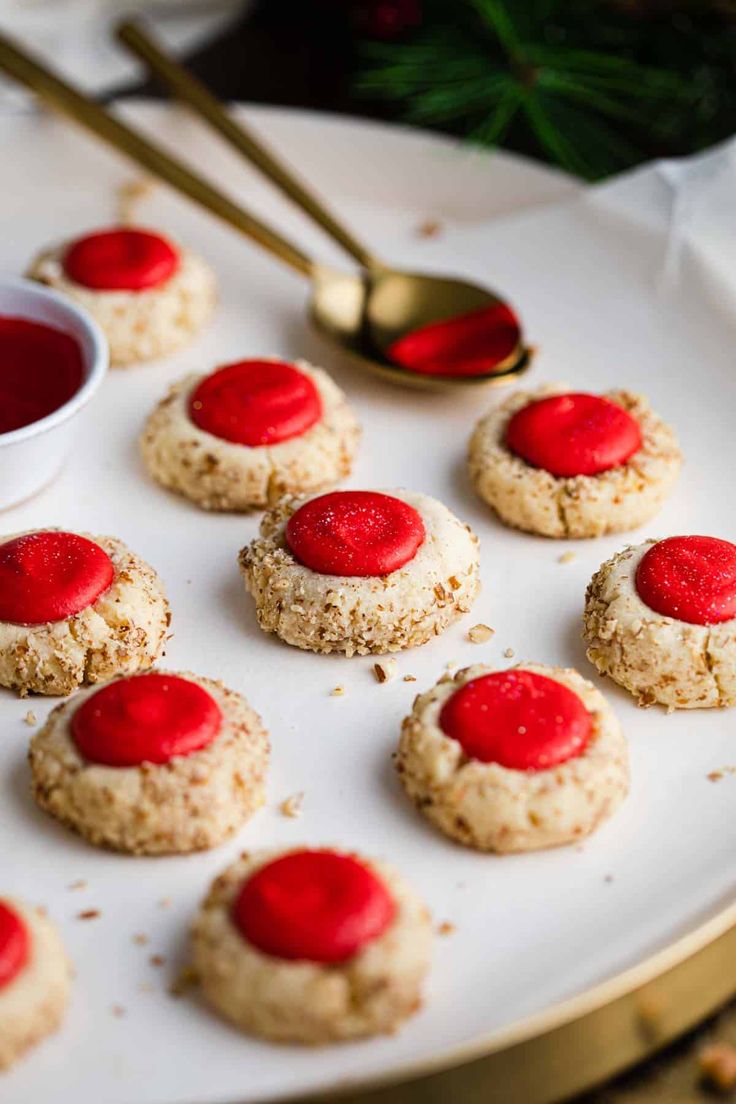 small cookies are arranged on a white plate