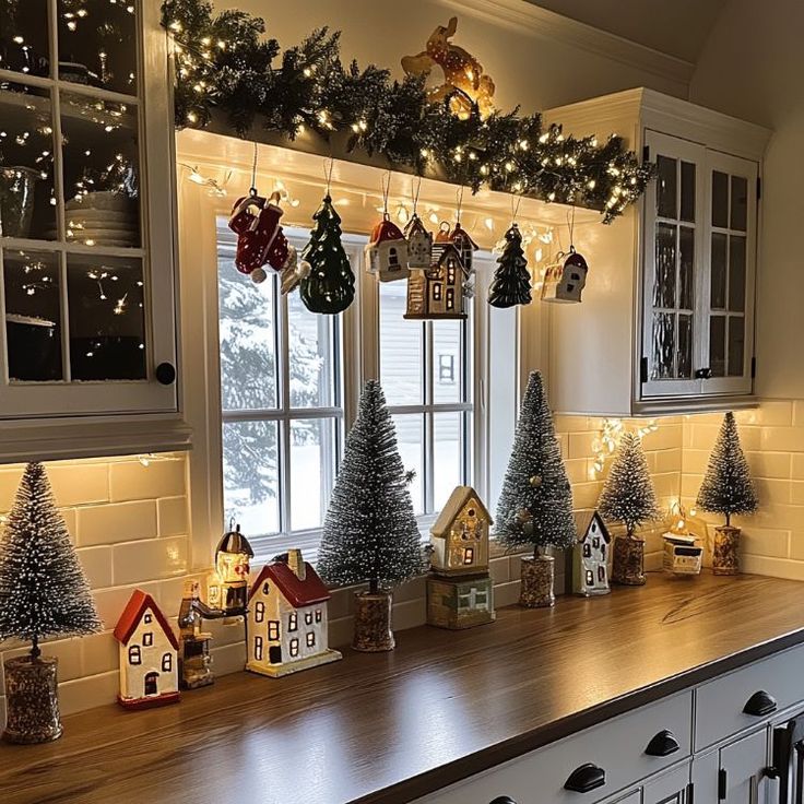 the kitchen counter is decorated with christmas trees and ornaments on it, along with other holiday decorations