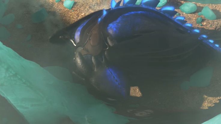 a blue and black baseball glove laying on top of some green plastic bags in the sand