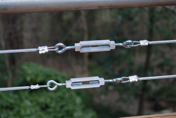 two metal chains are attached to a rail