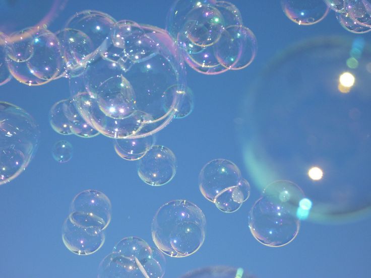 soap bubbles floating in the air on a sunny day