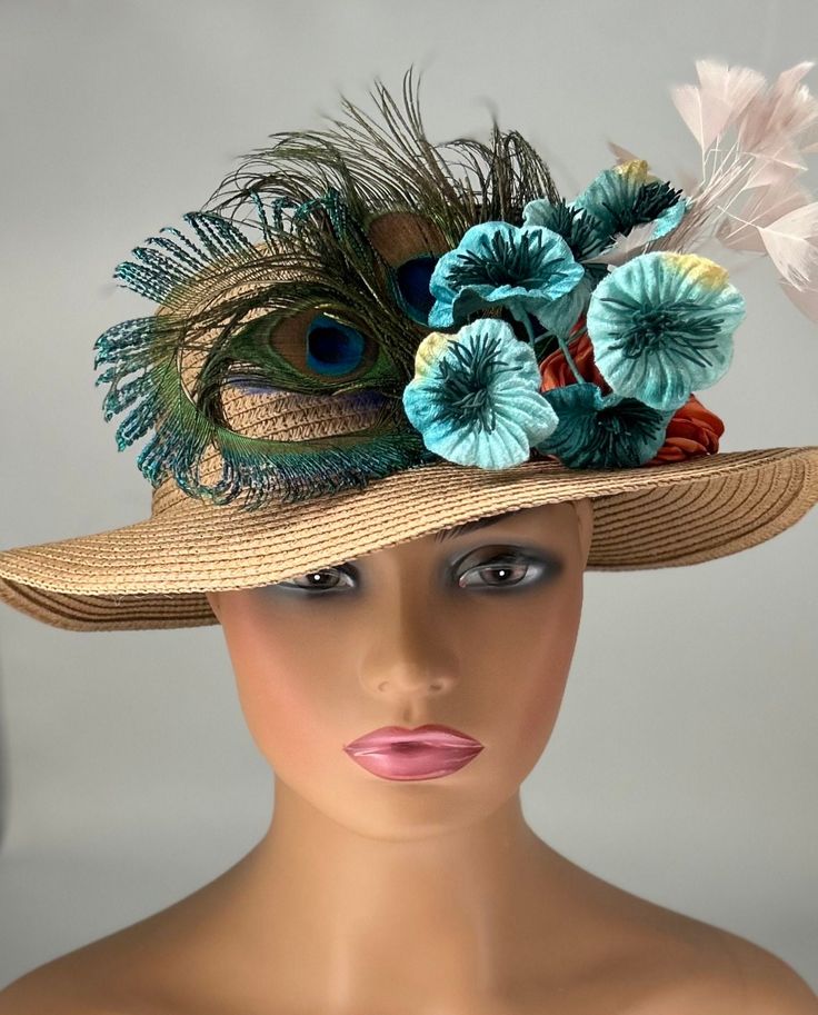 The hat featured here is a tan straw hat with a small brim and a beautiful   peacock feather design. Next to that are teal velvet flowers, an orange satin flower and a plumevif baby pink feathers. This is a one of a kind  hat  made by Letty. Creating the look that suits you best can be achieved just by  turning the hat on your head creating a different look with each twist till you find the look you love.. This gorgeous  hat is a beautiful Church hat or a Kentucky Derby Hat.  Also perfect  for  an Easter Hat, Tea Party hat, Wedding Party Hat, Fancy Dress Hat, Retro Hat and other special occasions hat. Brim:   2" Rise:   4" Size:    22" Handmade Straw Hat For Spring Country Events, Handmade Straw Hat For Country Events In Spring, Bohemian Straw Hat For Spring Party, Beach Hats With Feathers For Spring, Kentucky Derby Brimmed Straw Hat For Country Events, Bohemian Fedora Straw Hat For Parties, Kentucky Derby Straw Hat For Country Events, Fitted Bohemian Party Mini Hats, Bohemian Straw Hat For Kentucky Derby