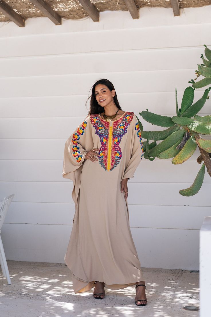 *Note : The kaftan in the video is a different color and is only displayed to show the fit, flow, and cut of the Kaftan. You will receive the one in the pictures.* A bohemian flash caftan made of light mesh of linen and poly, the fabric is unique in that it's very flowy and not the usual feel and touch of linen. This Kaftan is ideal to wear for any casual occasion. Whether taking a trip down the shopping lane, or home-based kitty parties, or about anything else, wearing this dress will make you Festive Bohemian Kaftan With Dabka Detailing, Festive Bohemian Kaftan With Dabka, Festive Kaftan With Embroidered Border, Floor-length Resham Embroidered Kaftan, Bohemian Kaftan With Resham Embroidery For Festivals, Dabka Embroidered Tunic Kaftan For Festivals, Festive Beige Kaftan With Resham Embroidery, Bohemian Maxi Length Abaya For Eid, Multicolor Bohemian Abaya For Beach