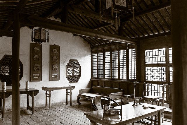 an old photo of a room with wooden tables and benches in the middle of it