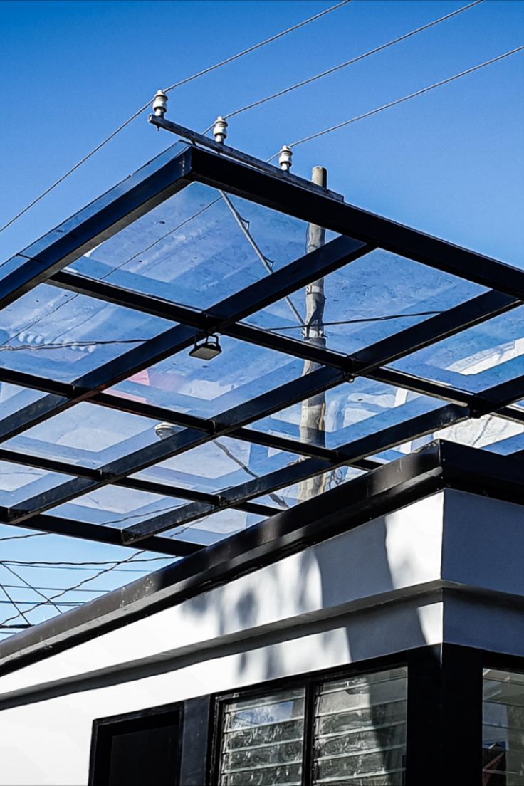 the roof of a building with birds perched on it's top and wires above