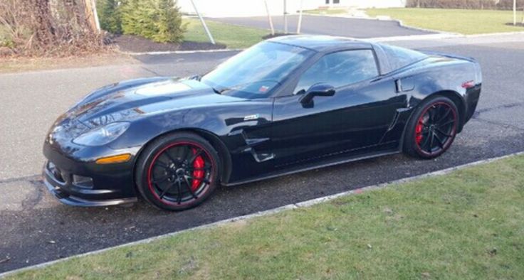 a black sports car is parked on the side of the road