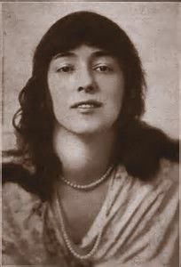 an old black and white photo of a woman with long hair wearing a pearl necklace