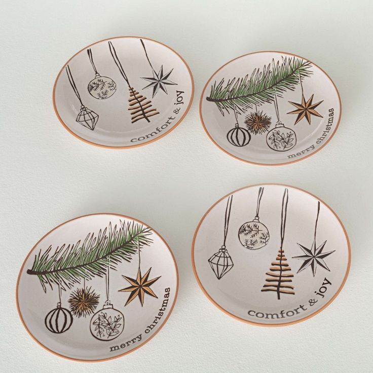 four plates with ornaments hanging from them