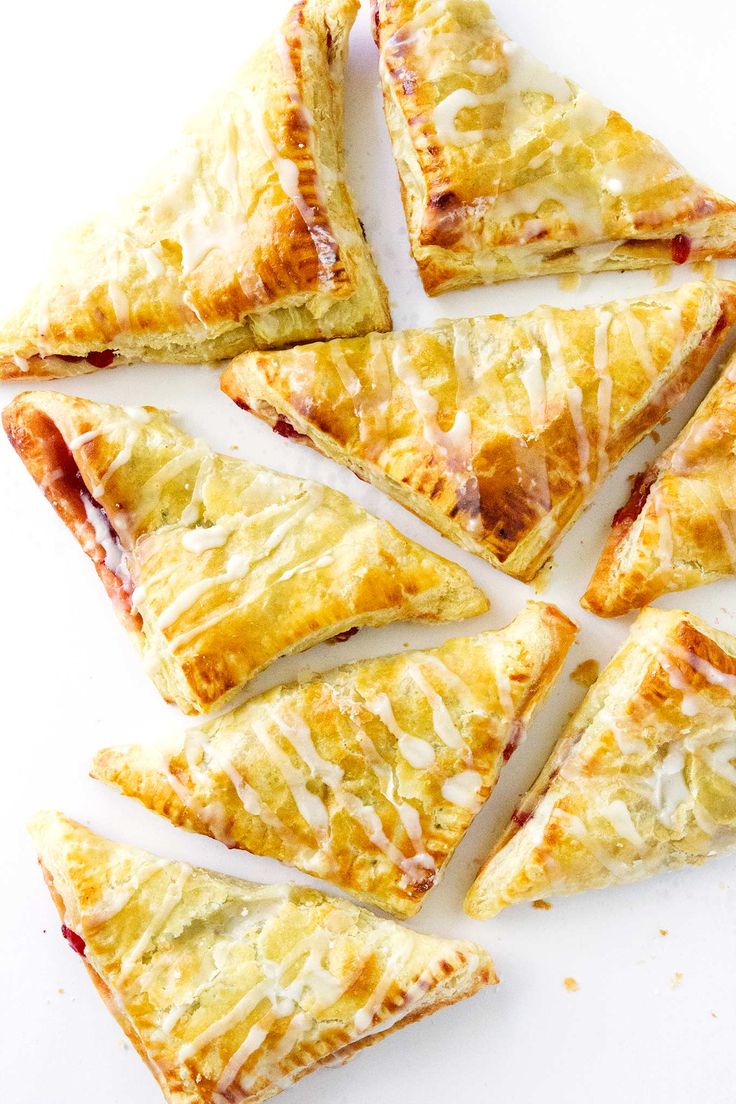 several pieces of pizza sitting on top of a white surface