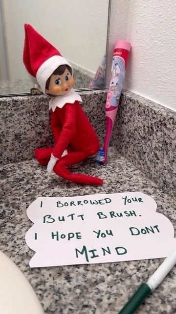 an elf is sitting in the bathroom sink next to a toothbrush and sign that says, i hope you don't mind