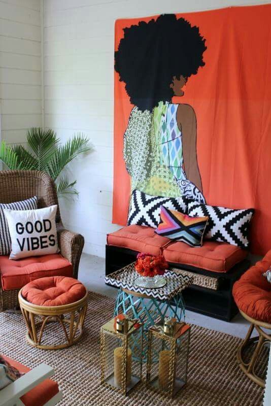 an image of a woman sitting on a chair in front of a wall with orange curtains