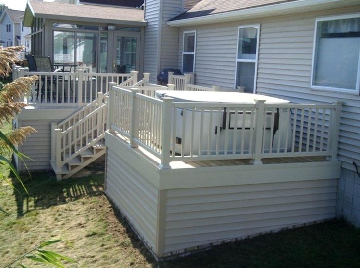 a white deck in front of a house