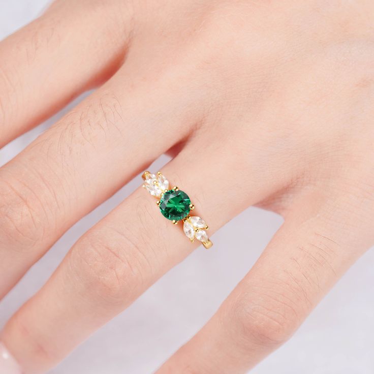 Make your style known with our breathtaking Ada emerald ring. Made on a base of Sterling Silver 925 and finished with a beautiful center emerald, this bold contrast will add a unique luxury to any outfit. Plus, our gorgeous CZ crystals further accentuate the shine, giving you a design you’ll simply adore. ✦ DETAILS ✦✧ Handcrafted ✧ 0.75 Carat center stone✧ Emerald and cz crystals ✧ Sizes 3.5-11✧ Rose gold over sterling silver 925, gold over sterling silver 925, or sterling silver 925 Green Emerald Promise Ring With Ethical Gemstones, Green Emerald Ring With Brilliant Cut For Promise, Luxury Emerald Birthstone Ring For Promise, Green Emerald Ring With Center Stone For Promise, Fine Jewelry Green Diamond Promise Ring, Green Emerald Ring With Accent Stones For May Birthstone, Luxury Emerald Birthstone Promise Ring, Classic Emerald Ring For Promise, Green Emerald Promise Ring With Center Stone