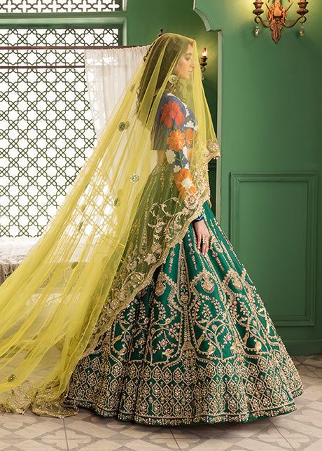 Blue Green Bridal Lehenga Choli for Indian Bridal Wear is pure raw silk pure lehnga in emerald green is hand-rendered in gold and is enhanced with naqshi, Sitara, and dabka and leather motifs. The ink blue raw silk choli has gorgeous Suzanne motifs with Sitara work and is paired with a yellow net dupatta that is framed with an aari border and Kiran. The stunning yellow veil with aari work, pearls, and Sitara is the star of the show. Choli: Glamour meets opulence in this ethereal cappuccino and g Green Choli With Cutdana For Reception, Green Cutdana Dupatta For Reception, Green Silk Sets For Reception, Green Raw Silk Anarkali Set For Reception, Green Tissue Silk Saree For Reception, Green Organza Traditional Wear For Reception, Green Organza Choli For Reception, Green Anarkali Set With Traditional Drape In Tissue Silk, Green Anarkali Set In Tissue Silk With Traditional Drape