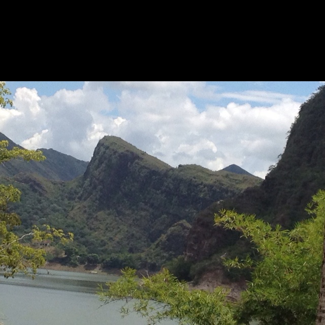 there is a boat on the water near mountains