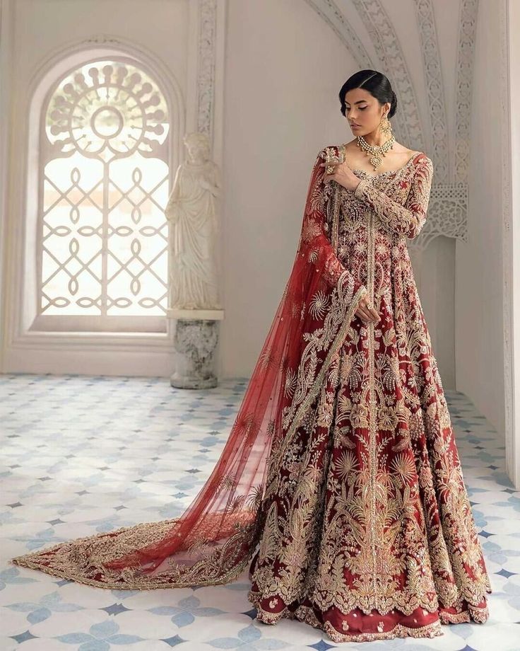 Red Lehenga With Sheer Dupatta And Long Sleeves, Anarkali Sharara With Dabka Work, Anarkali Sharara With Dabka Work And Traditional Drape, Designer Floor-length Anarkali Set With Zari Work, Eid Anarkali Set With Intricate Embroidery, Anarkali Sharara With Resham Embroidery For Reception, Traditional Reception Gown With Dabka Work, Traditional Gown With Resham Embroidery For Reception, Semi-stitched Kundan Gown With Intricate Embroidery