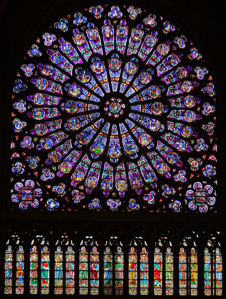 a large stained glass window in the middle of a building with multiple colors on it