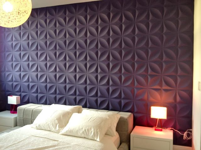 a bedroom with purple walls and white bedding, two night stands on either side