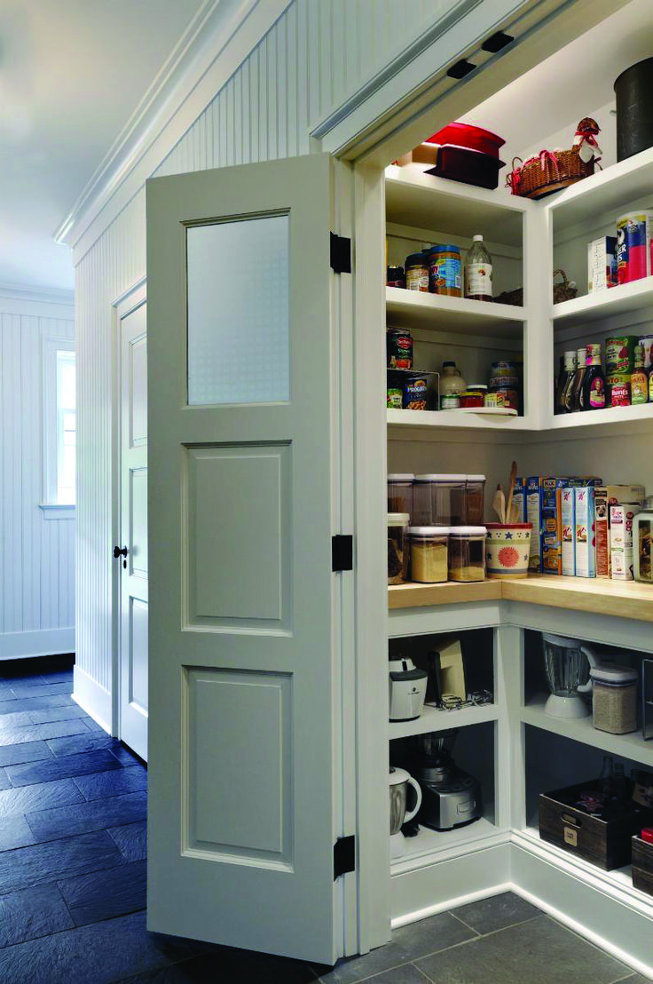 an open pantry door in the middle of a kitchen with lots of food on shelves