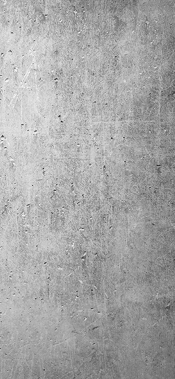 a black and white photo of a person on a skateboard in front of a concrete wall