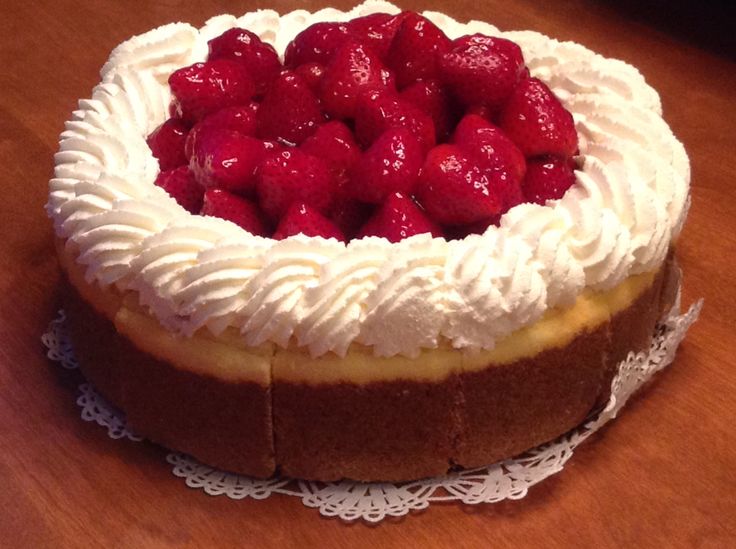 a cake with white frosting and strawberries on top