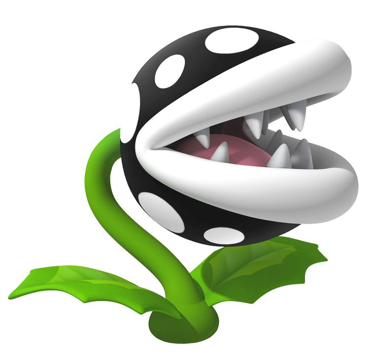 a black and white ball with its mouth open sitting on top of a green plant