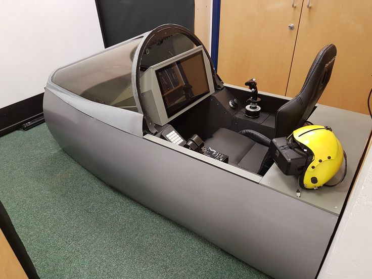 an inflatable boat with a steering wheel and a helmet on the seat is shown