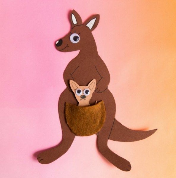 a felt kangaroo and its baby are hanging on a pink background with an orange backdrop