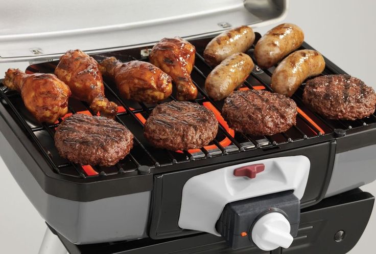 an electric grill with hamburgers and donuts on it