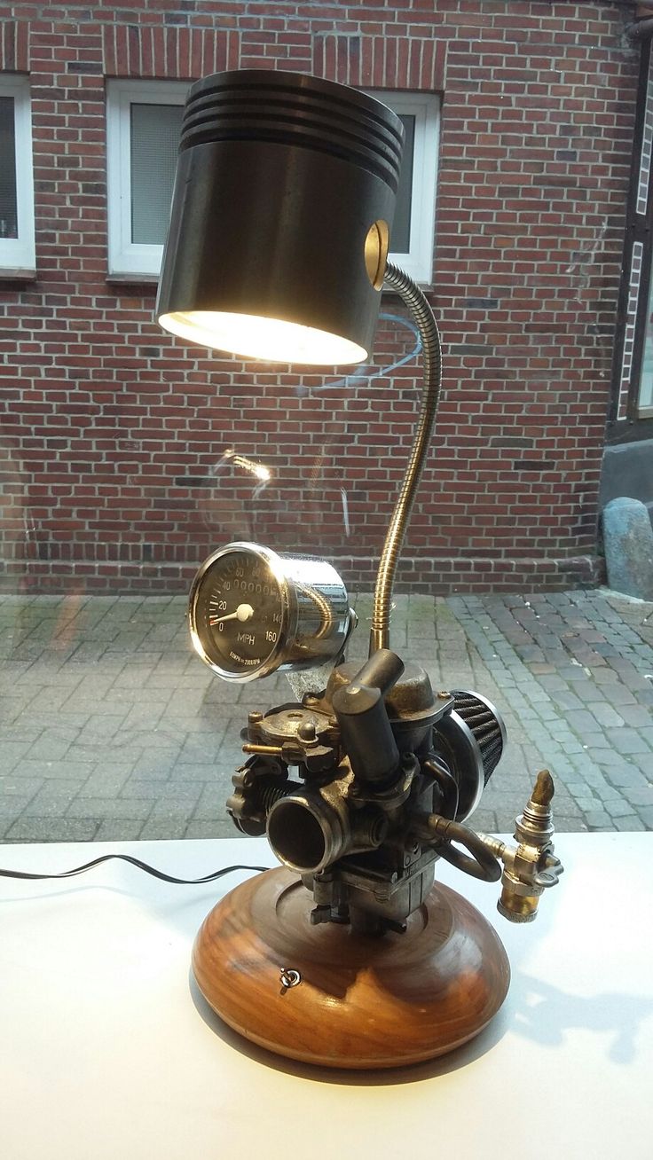 a lamp that is sitting on top of a table in front of a brick building