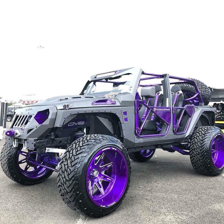 a gray and purple jeep parked in a parking lot