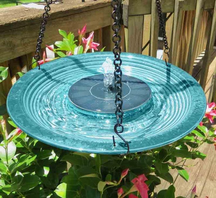 a blue bird bath hanging from a chain