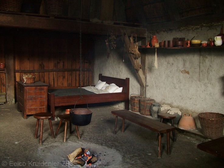 an old fashioned bedroom with wood furniture and baskets