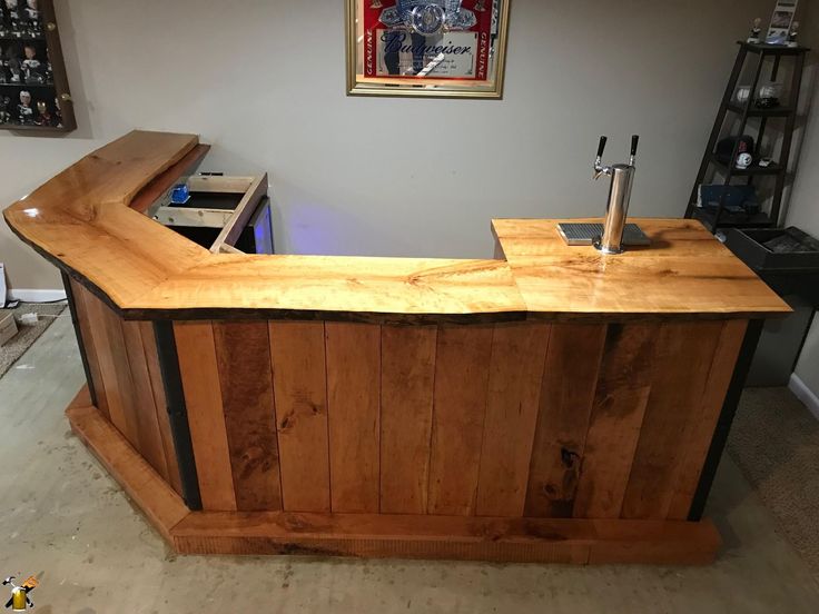 a wooden counter top sitting in the middle of a living room next to a wall